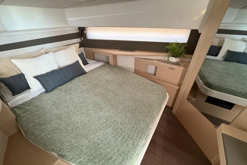  Yacht Photos Pics Luxurious cabin interior of 2026 Jeanneau DB/37 OB yacht with cozy bedding.