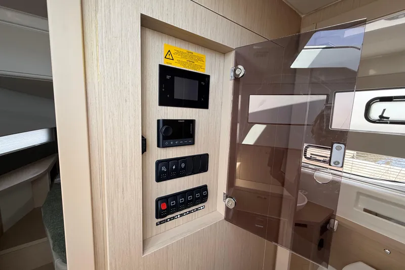  Yacht Photos Pics Control panel inside 2026 Jeanneau DB/37 OB boat, featuring modern switches and displays.