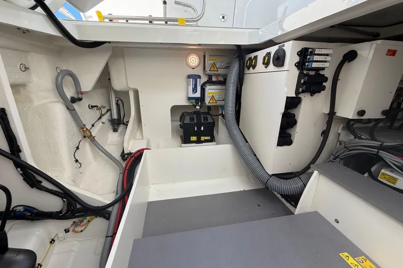 Yacht Photos Pics Engine compartment of 2026 Jeanneau DB/37 OB boat, showcasing wiring and mechanical components.