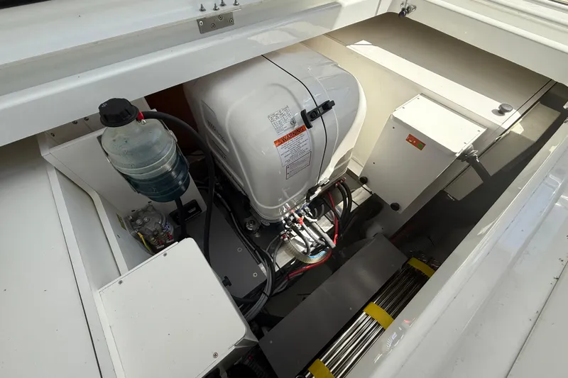  Yacht Photos Pics Engine compartment of 2026 Jeanneau DB/37 OB boat, showcasing mechanical components and wiring.