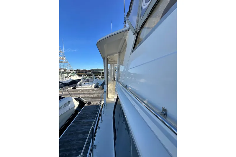 Alyce's Palace II Yacht Photos Pics 1995 Carver 440 Aft Cabin Motor Yacht docked at marina under clear blue sky.