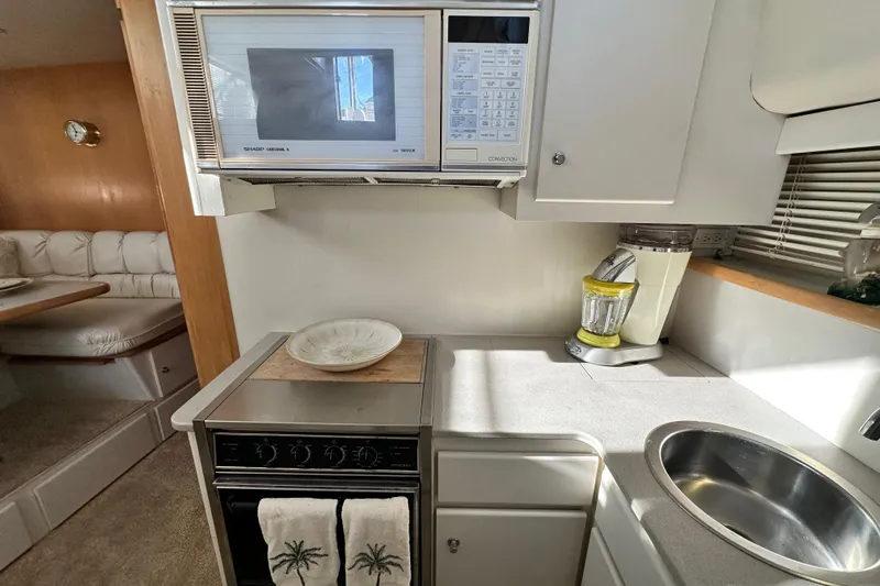 Alyce's Palace II Yacht Photos Pics 1995 Carver 440 Aft Cabin Motor Yacht kitchen with microwave, stove, and sink.
