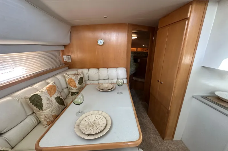 Alyce's Palace II Yacht Photos Pics Interior of 1995 Carver 440 Aft Cabin Motor Yacht with dining area and cozy seating.