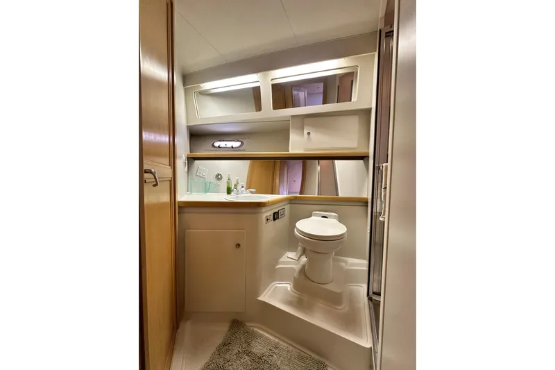 Alyce's Palace II Yacht Photos Pics Bathroom interior of 1995 Carver 440 Aft Cabin Motor Yacht, featuring toilet and sink.
