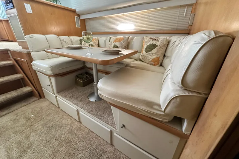 Alyce's Palace II Yacht Photos Pics Luxurious dining area in 1995 Carver 440 Aft Cabin Motor Yacht with plush seating.