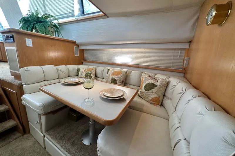 Alyce's Palace II Yacht Photos Pics Cozy dining area in 1995 Carver 440 Aft Cabin Motor Yacht with plush seating and decor.
