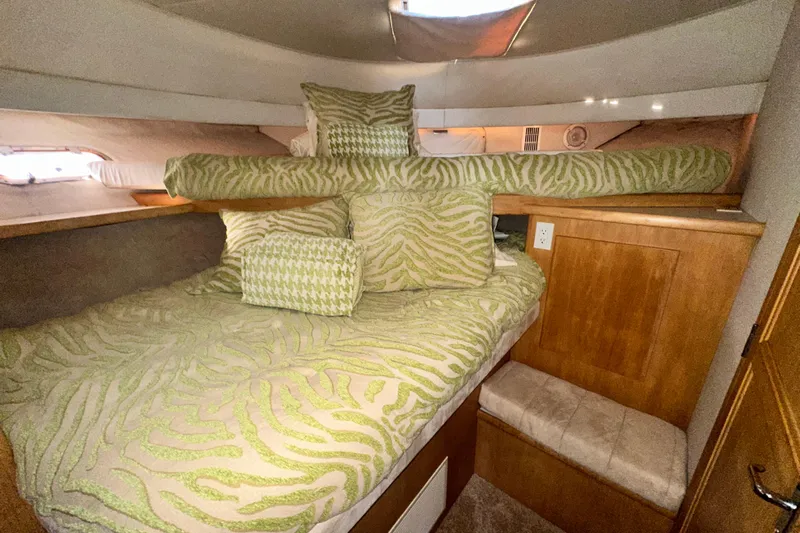 Alyce's Palace II Yacht Photos Pics Cozy cabin interior of 1995 Carver 440 Aft Cabin Motor Yacht with patterned bedding.