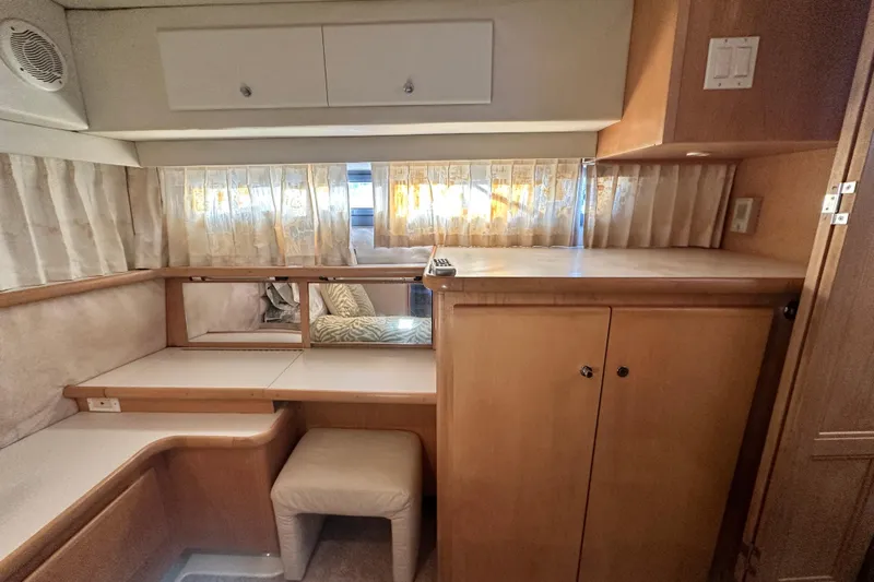 Alyce's Palace II Yacht Photos Pics 1995 Carver 440 Aft Cabin Motor Yacht interior with wooden cabinetry and seating area.