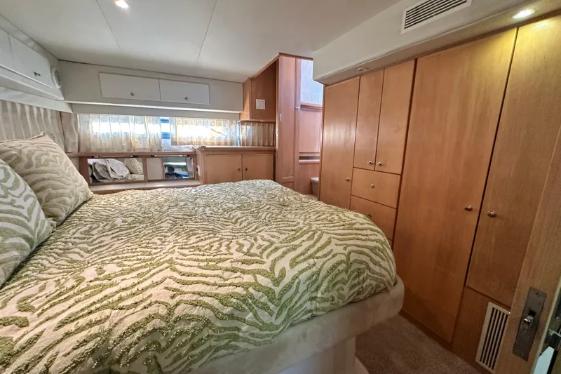 Alyce's Palace II Yacht Photos Pics Luxurious bedroom in 1995 Carver 440 Aft Cabin Motor Yacht with elegant wood cabinetry.