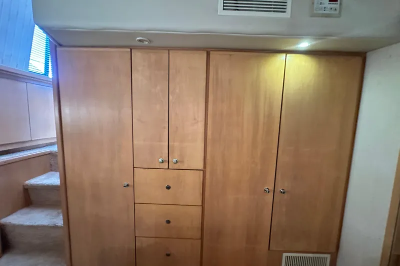 Alyce's Palace II Yacht Photos Pics Wooden cabinetry inside 1995 Carver 440 Aft Cabin Motor Yacht, featuring drawers and storage.