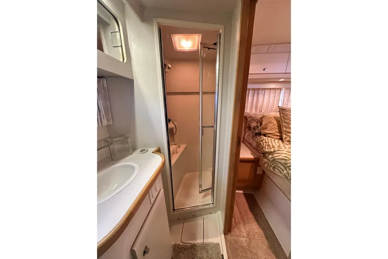 Alyce's Palace II Yacht Photos Pics 1995 Carver 440 Aft Cabin Motor Yacht interior with bathroom and cozy bedroom.