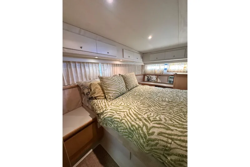 Alyce's Palace II Yacht Photos Pics Cozy bedroom in 1995 Carver 440 Aft Cabin Motor Yacht with patterned bedding.