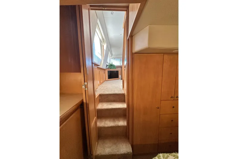 Alyce's Palace II Yacht Photos Pics Interior of 1995 Carver 440 Aft Cabin Motor Yacht with wooden cabinetry and carpeted stairs.