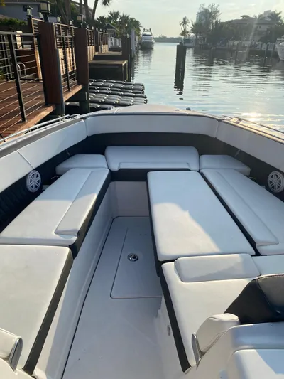  Yacht Photos Pics 2019 Monterey 378 boat interior with white seating, docked by a calm waterfront.