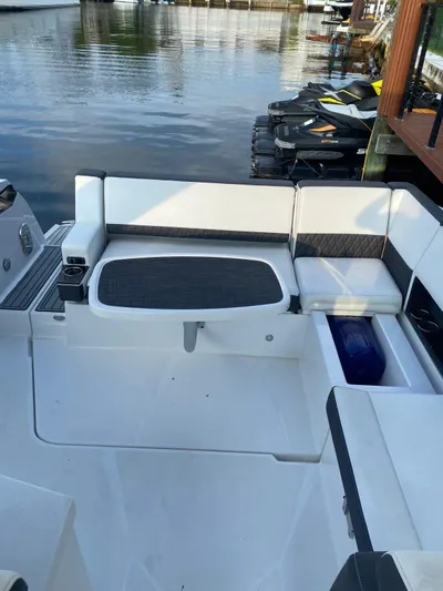  Yacht Photos Pics 2019 Monterey 378 boat interior with white seating, docked by calm water.