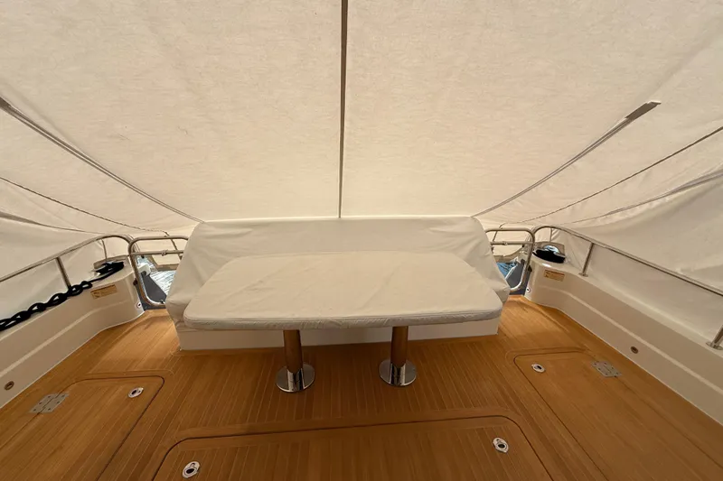  Yacht Photos Pics 2021 Sabre 58 Salon Express yacht interior with covered seating and wooden deck.