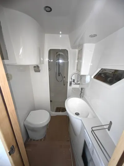  Yacht Photos Pics Modern bathroom in 2025 ArrowCat 420 Flybridge yacht with shower, sink, and toilet.