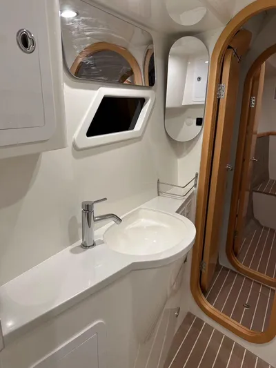  Yacht Photos Pics Modern bathroom in 2025 ArrowCat 420 Flybridge yacht with sleek fixtures and wooden accents.