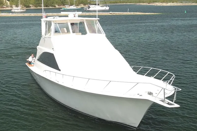 Bella Donna Yacht Photos Pics 1999 Ocean Yachts 56 cruising on calm waters, showcasing sleek design and spacious deck.