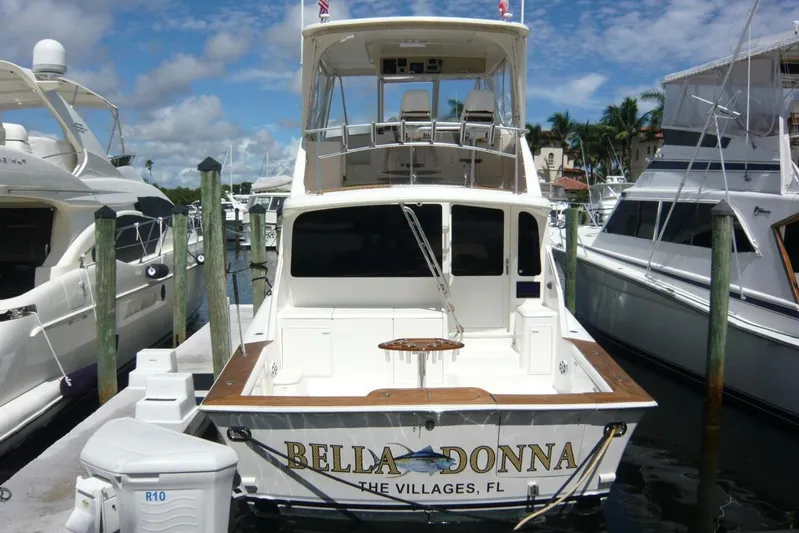 Bella Donna Yacht Photos Pics 1999 Ocean Yachts 56 docked at marina, sunny day, clear sky, surrounded by other boats.