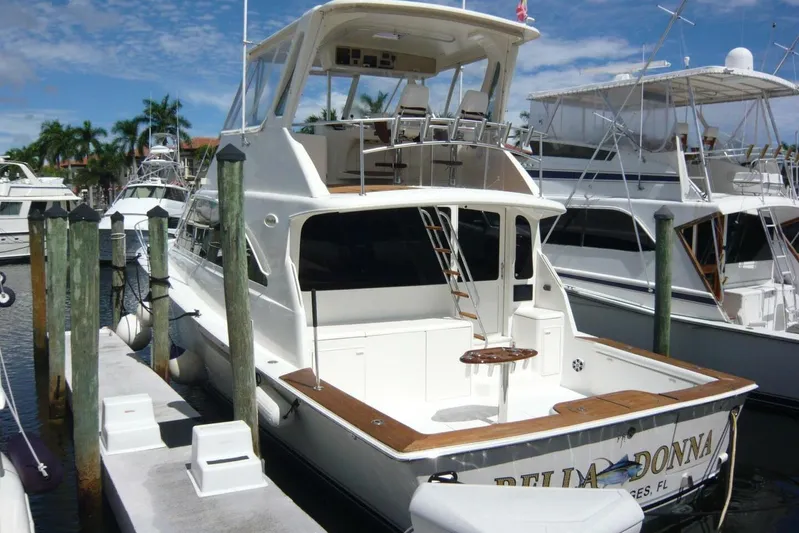 Bella Donna Yacht Photos Pics 1999 Ocean Yachts 56 docked at marina, featuring spacious deck and flybridge.