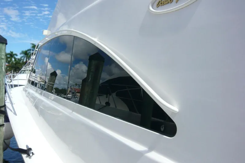Bella Donna Yacht Photos Pics Side view of a 1999 Ocean Yachts 56, showcasing sleek design and reflective windows.