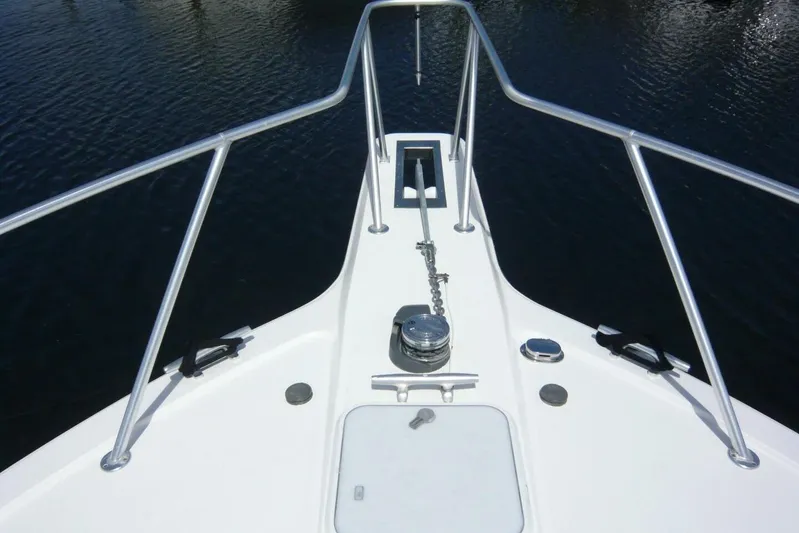 Bella Donna Yacht Photos Pics Bow view of 1999 Ocean Yachts 56, featuring anchor chain and railing over water.