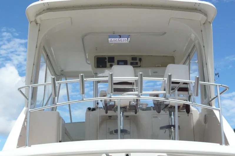 Bella Donna Yacht Photos Pics 1999 Ocean Yachts 56 cockpit with helm chairs and control panel under clear blue sky.