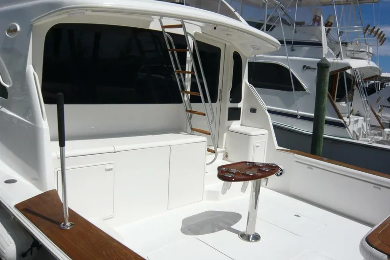 Bella Donna Yacht Photos Pics 1999 Ocean Yachts 56, spacious deck with seating and ladder, docked at marina.