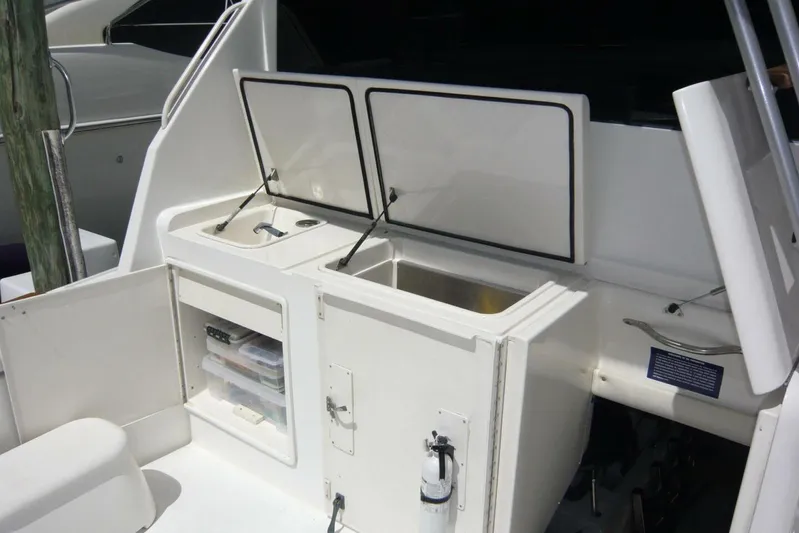 Bella Donna Yacht Photos Pics 1999 Ocean Yachts 56 boat deck with open storage compartments and sink.