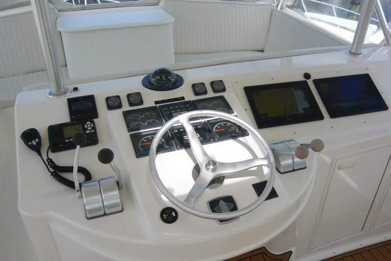Bella Donna Yacht Photos Pics Control panel of a 1999 Ocean Yachts 56, featuring steering wheel and navigation instruments.