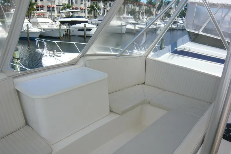Bella Donna Yacht Photos Pics 1999 Ocean Yachts 56 interior with white seating, marina view in background.