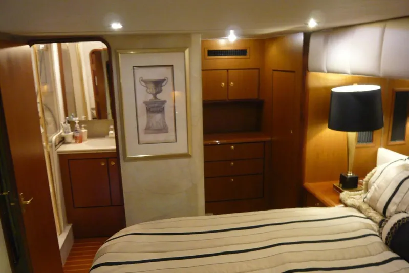 Bella Donna Yacht Photos Pics Luxurious 1999 Ocean Yachts 56 interior cabin with elegant wood finish and cozy bedding.