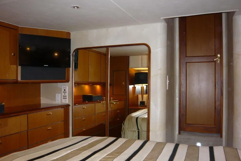 Bella Donna Yacht Photos Pics Luxurious cabin interior of 1999 Ocean Yachts 56, featuring wood cabinetry and modern amenities.