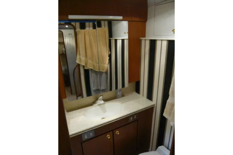 Bella Donna Yacht Photos Pics Bathroom interior of 1999 Ocean Yachts 56, featuring a sink and mirror.