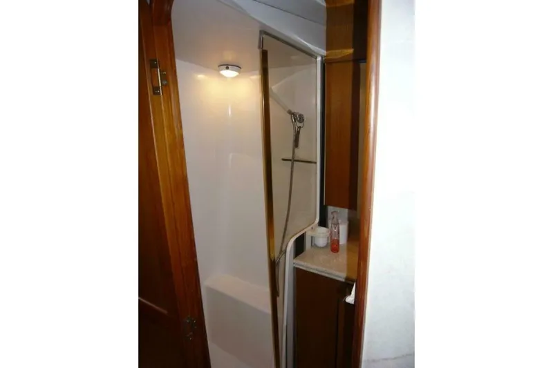 Bella Donna Yacht Photos Pics Shower area in 1999 Ocean Yachts 56, featuring wooden cabinetry and modern fixtures.