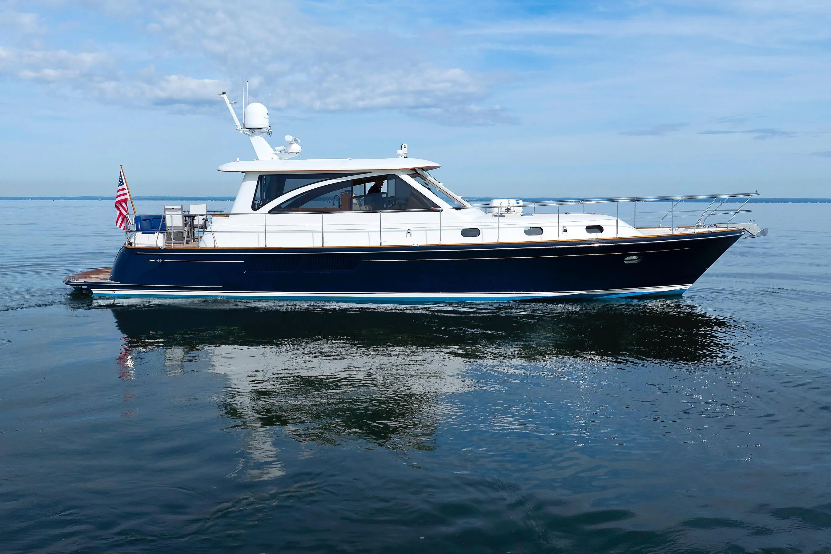 2009 Hunt Yachts 52 Express cruising on calm waters under a blue sky.
