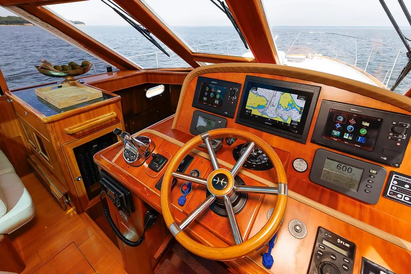 Independence Yacht Photos Pics Helm of 2009 Hunt Yachts 52 Express with navigation screens and wooden steering wheel.
