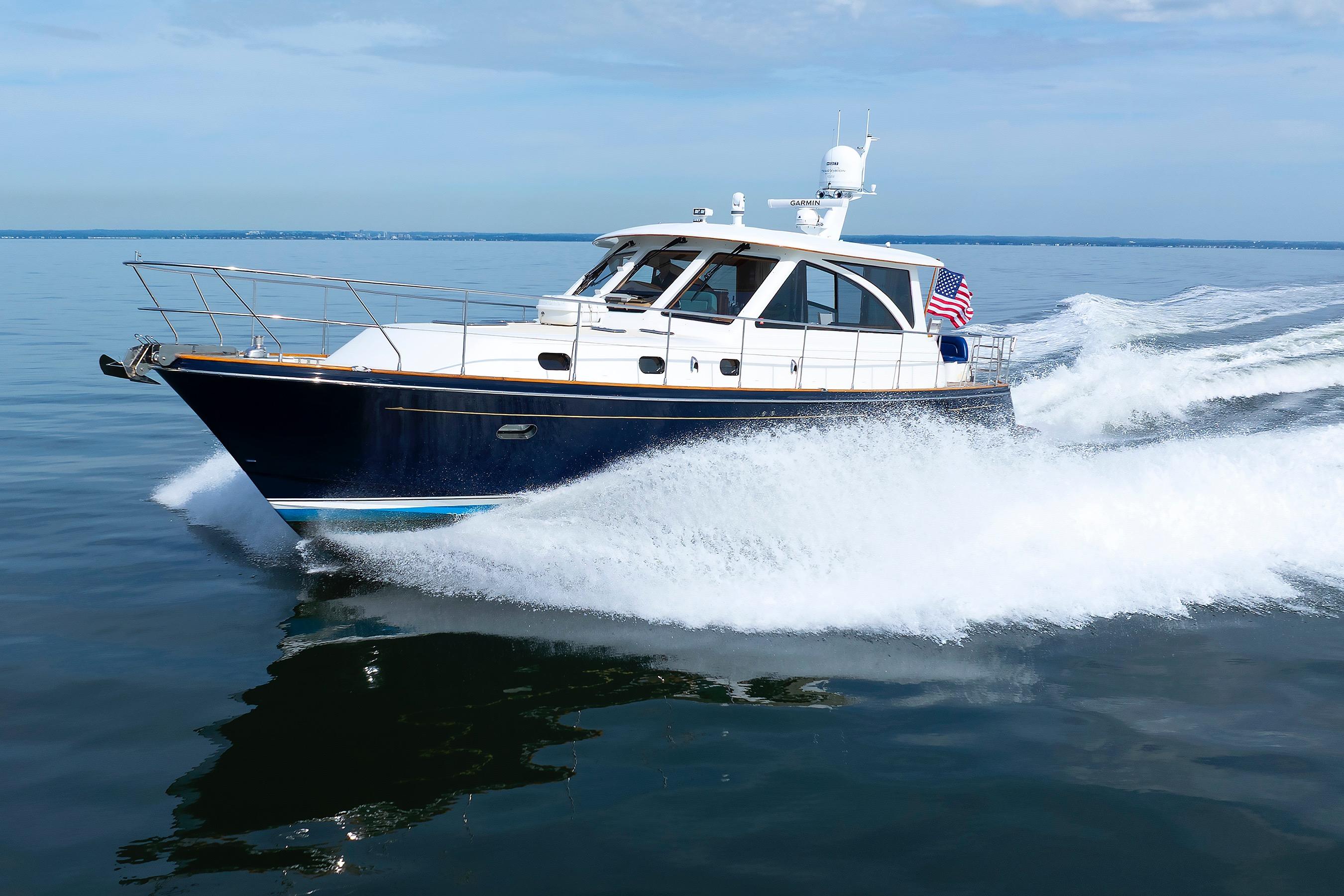 2009 Hunt Yachts 52 Express cruising on calm waters with American flag.