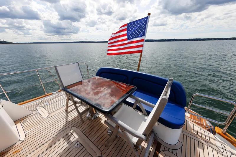 Independence Yacht Photos Pics Luxury deck of 2009 Hunt Yachts 52 Express with American flag and ocean view.
