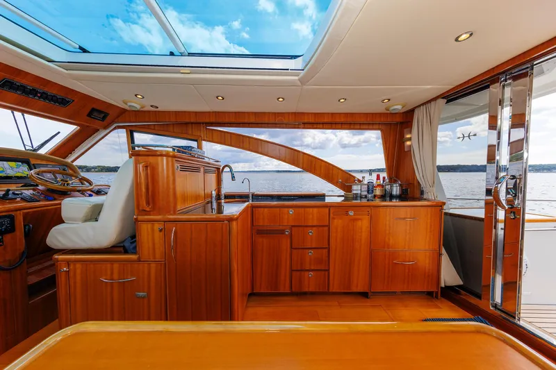 Independence Yacht Photos Pics Luxurious 2009 Hunt Yachts 52 Express interior with wooden cabinetry and ocean view.