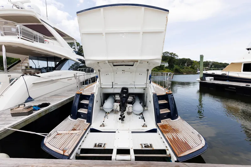 Independence Yacht Photos Pics 2009 Hunt Yachts 52 Express docked, showcasing open engine compartment and wooden deck.