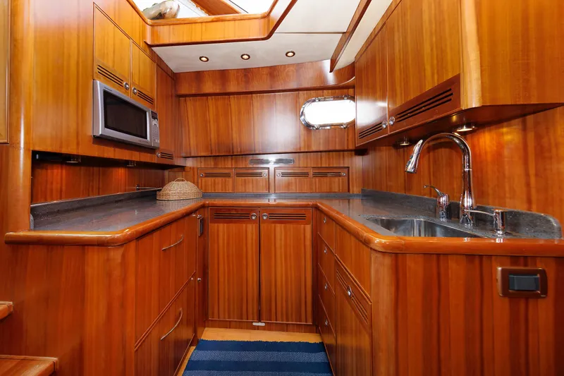 Independence Yacht Photos Pics Luxurious wooden kitchen interior of 2009 Hunt Yachts 52 Express, featuring modern amenities.