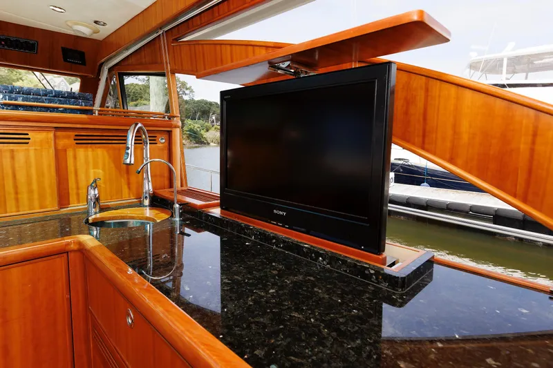 Independence Yacht Photos Pics Luxurious 2009 Hunt Yachts 52 Express interior with sleek kitchen and pop-up TV.