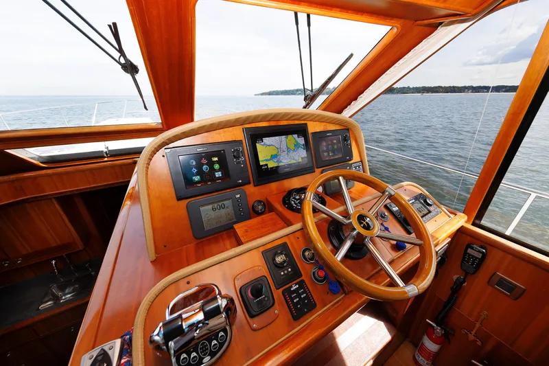 Independence Yacht Photos Pics Helm of 2009 Hunt Yachts 52 Express with navigation screens and wooden steering wheel.