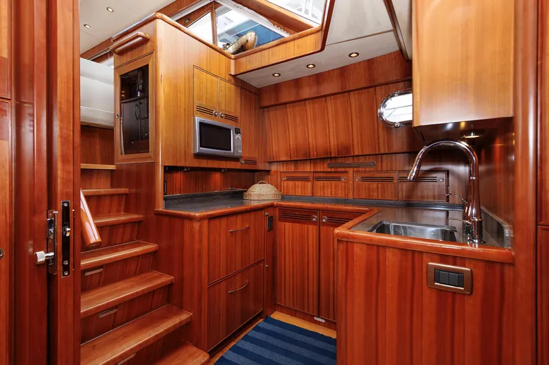 Independence Yacht Photos Pics Luxurious wooden interior of 2009 Hunt Yachts 52 Express, featuring a modern kitchen.