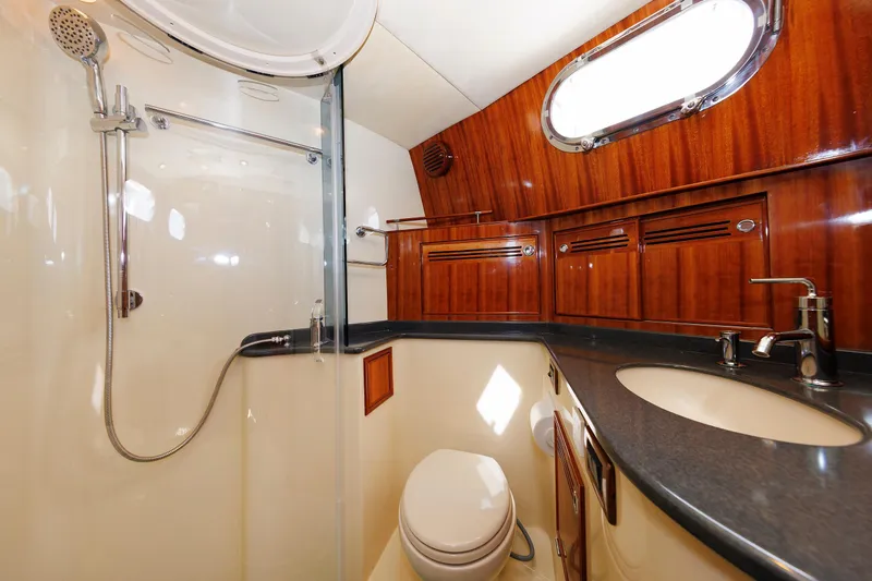 Independence Yacht Photos Pics Luxurious bathroom in 2009 Hunt Yachts 52 Express with wood accents and modern fixtures.