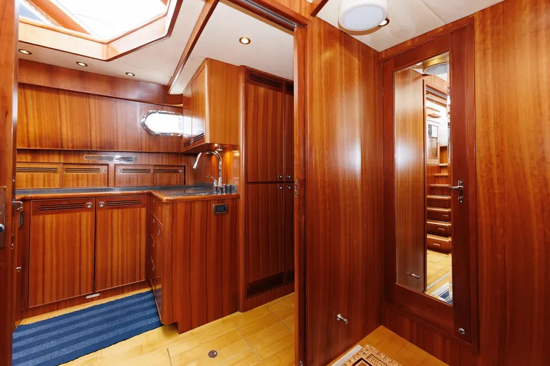 Independence Yacht Photos Pics Luxurious wooden interior of 2009 Hunt Yachts 52 Express, featuring a compact kitchen area.