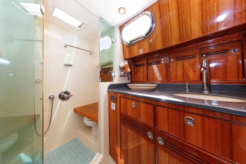 Independence Yacht Photos Pics Luxurious 2009 Hunt Yachts 52 Express bathroom with wood cabinetry and glass shower.