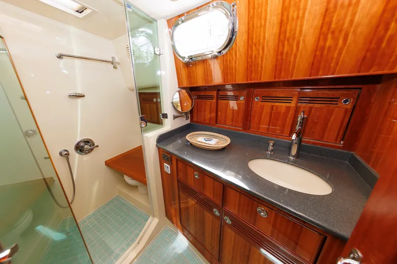 Independence Yacht Photos Pics Luxurious bathroom in 2009 Hunt Yachts 52 Express, featuring wood cabinetry and modern fixtures.